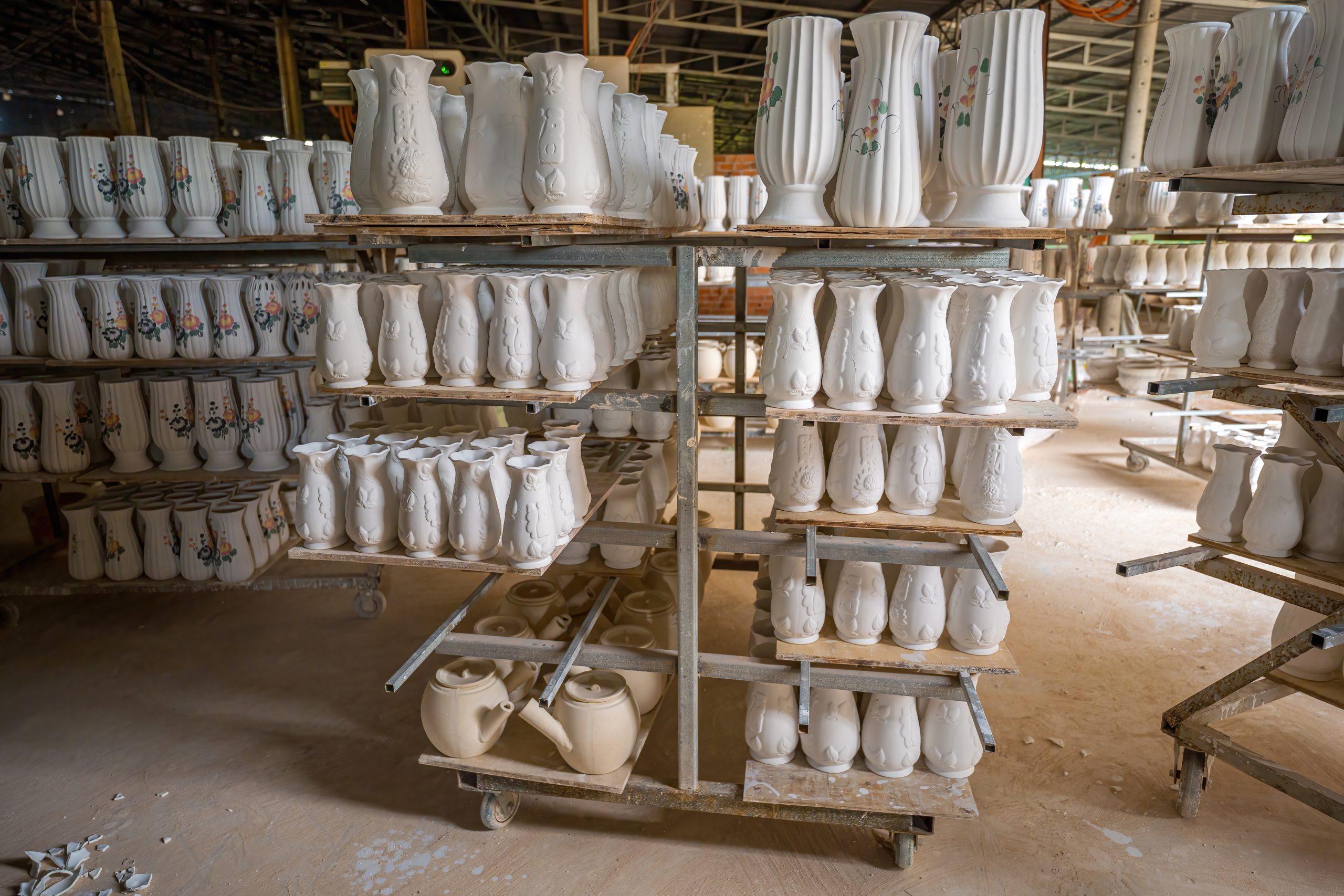 Ceramic placed in rows waiting to burn in the ceramic factory. Stack of raw small ceramic cups on shelf, ceramic cup mold, traditional making process of ceramic cups in the factory.